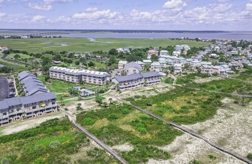 Oceanmarsh Subdivision Condo | Charming condo with a screened-in porch, water views, and access to complex pool