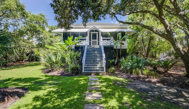 Vintage island cottage 1 block from beach with fenced yard, porch, & W/D