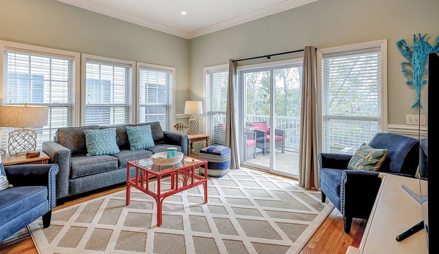 Welcoming water view townhome with pool, balcony, deck, & kitchen